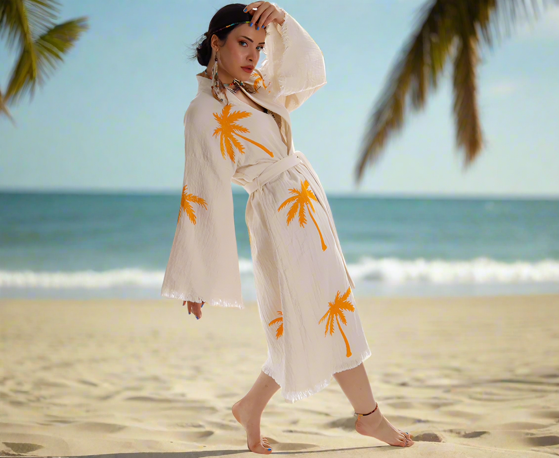A woman elegantly drapes herself in a Boho Palm Tree Stamped Organic Cotton Kimono Robe