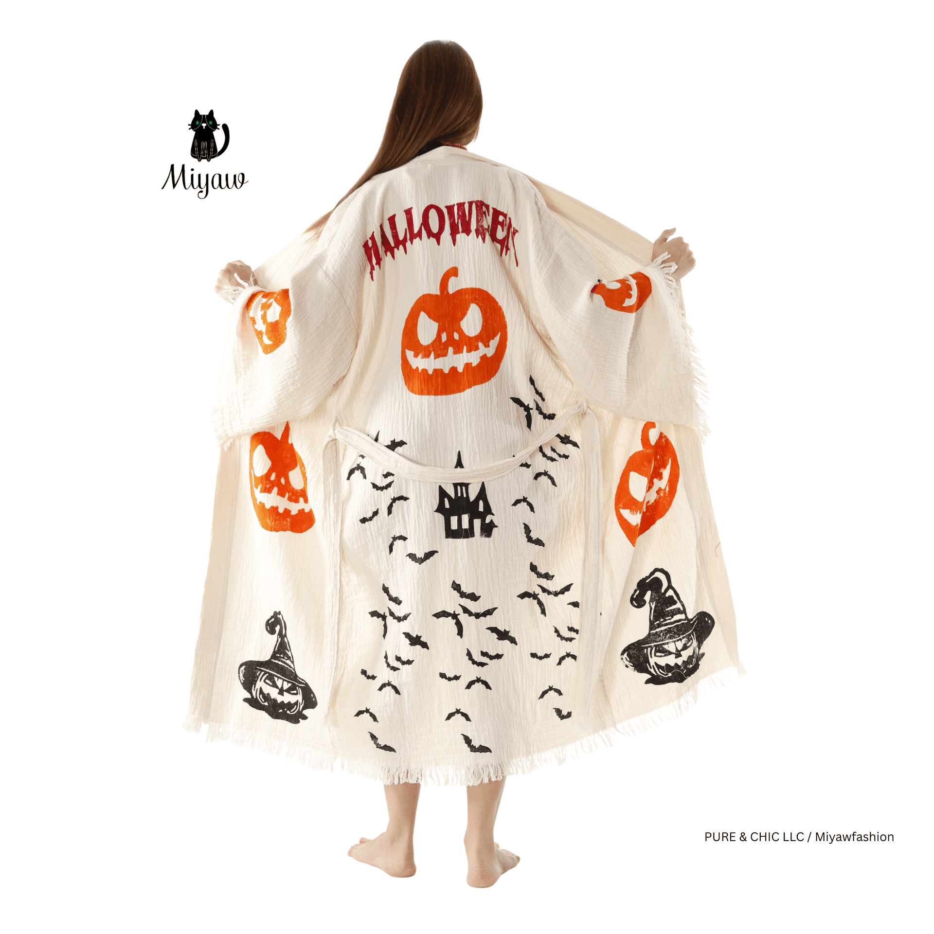 Woman wearing a Halloween-themed cape with pumpkins and bats on a white background