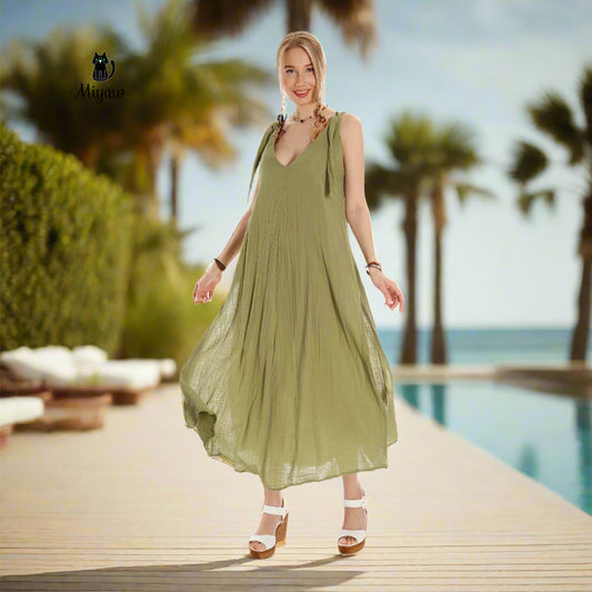 A gorgeous woman wearing a maxi dress stands near the pool at a resort in Rosemary Beach.