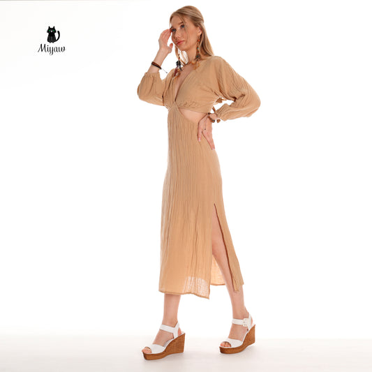 A woman wears a cut-out maxi dress in heels.