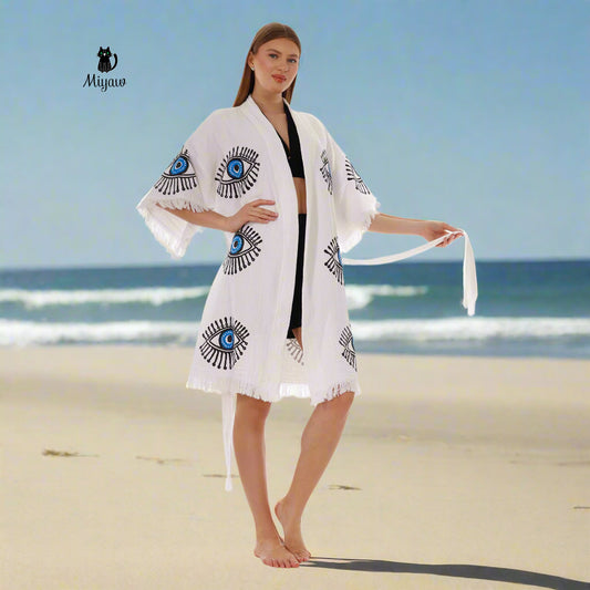 A woman is wearing a beach cover-up and is in barefoot.