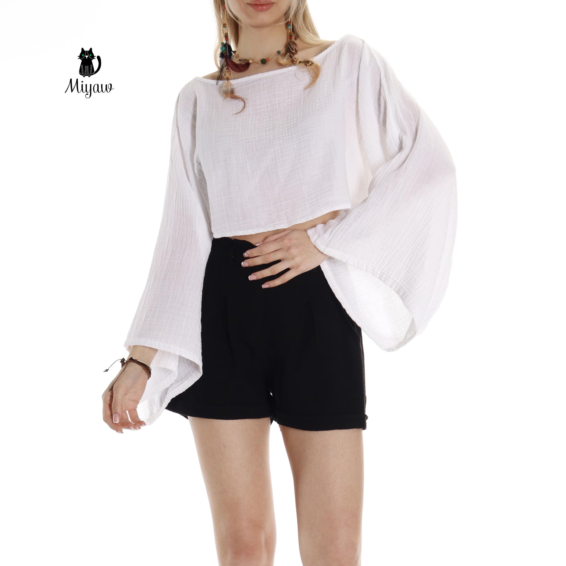 Model wearing white boho top with boat neck
