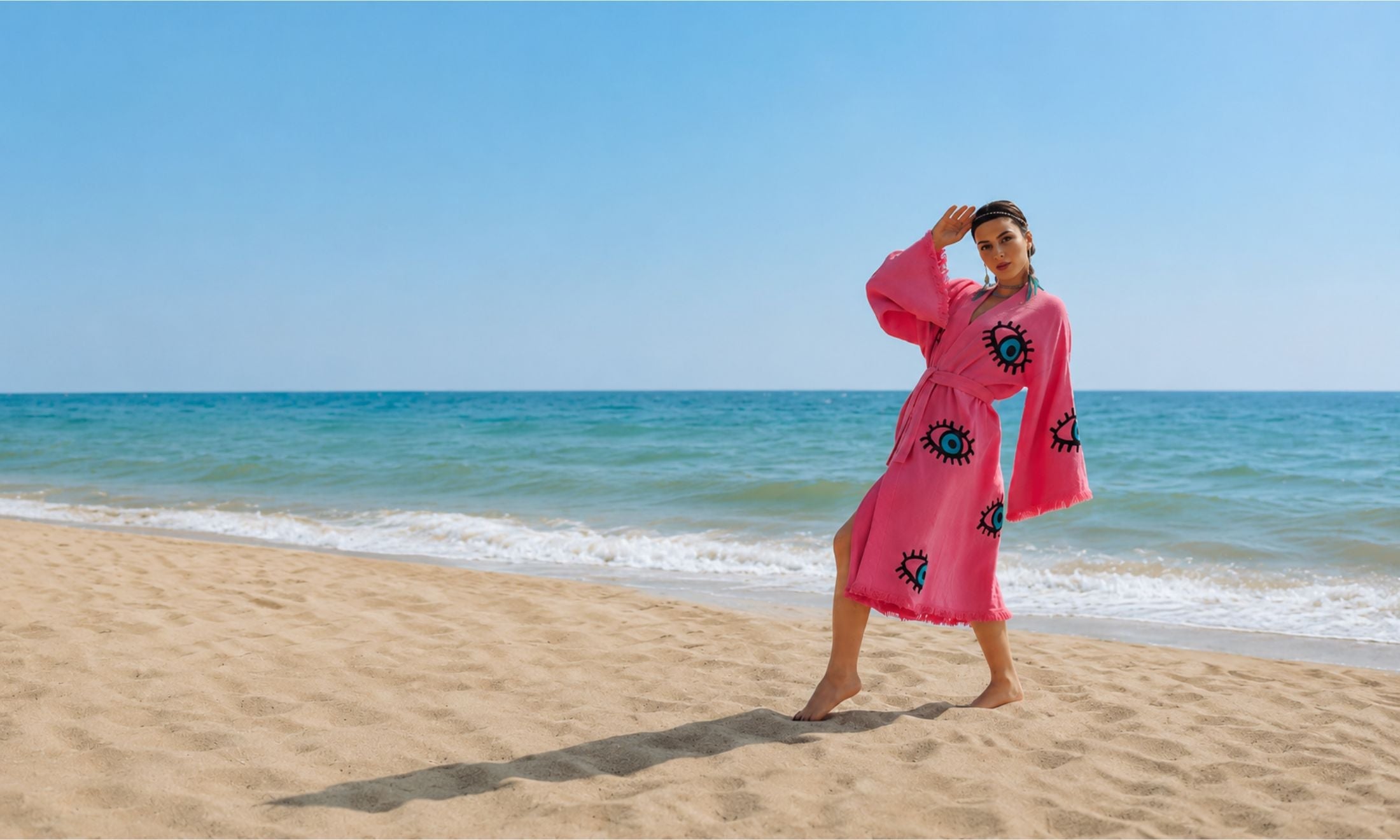 Handcrafted pink women's cotton kimono robe by MIYAW Fashion worn on a sandy beach as a lightweight resort and beach cover-up.