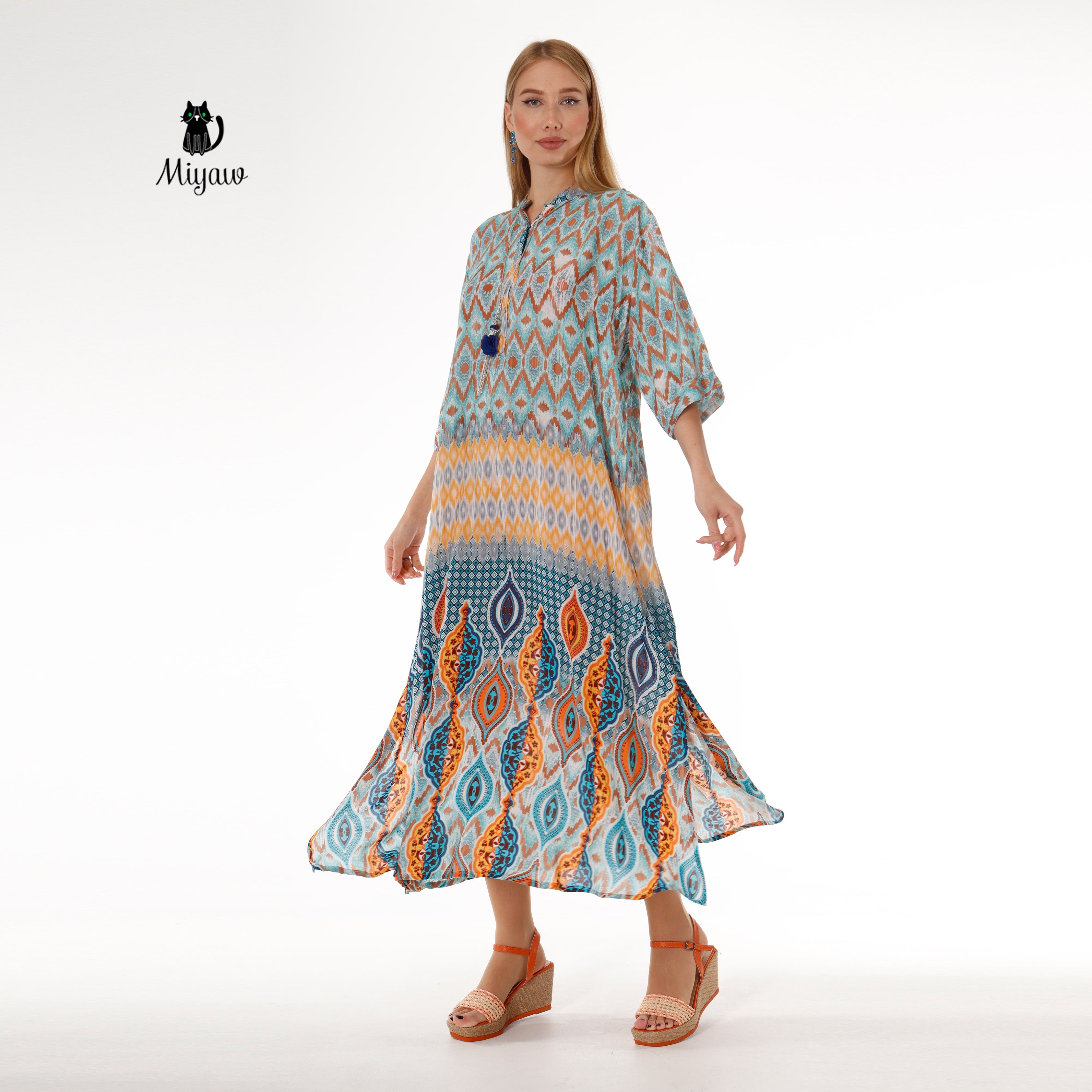 Bohemian woman in long blue dress with elegant batwing sleeves
