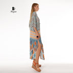 Woman in bohemian blue maxi dress with soft, draped batwing sleeves