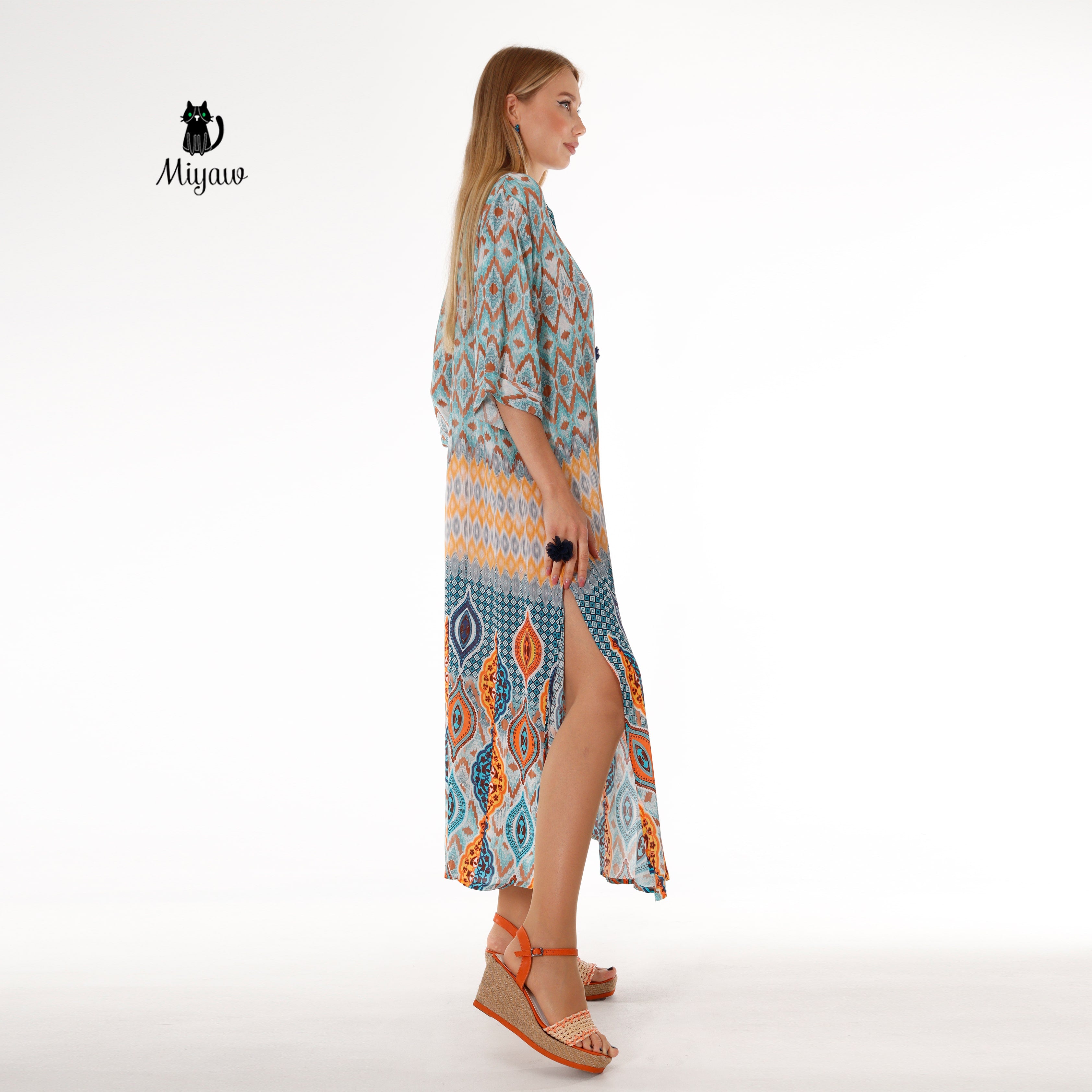 Woman in bohemian blue maxi dress with soft, draped batwing sleeves