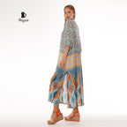 Woman dressed in a boho blue maxi dress with stylish batwing sleeves