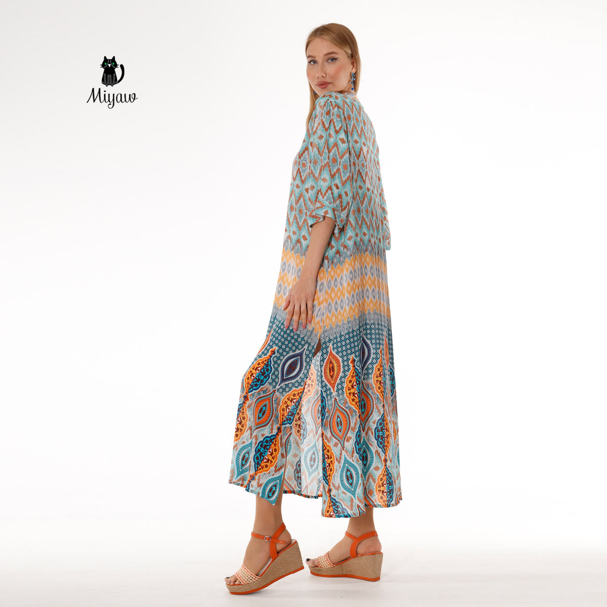 Woman dressed in a boho blue maxi dress with stylish batwing sleeves