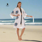 A woman is wearing a beach cover-up and is in barefoot.