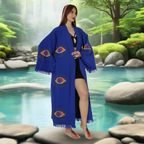 A woman is wearing a organic cotton blue kimono robe in the hot springs.