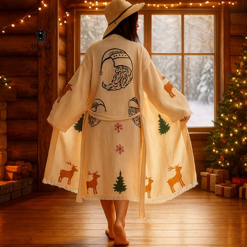 woman wearing your Christmas-themed robe with hand-stamped Santa hats, red snowflakes, green pine trees, and golden reindeer