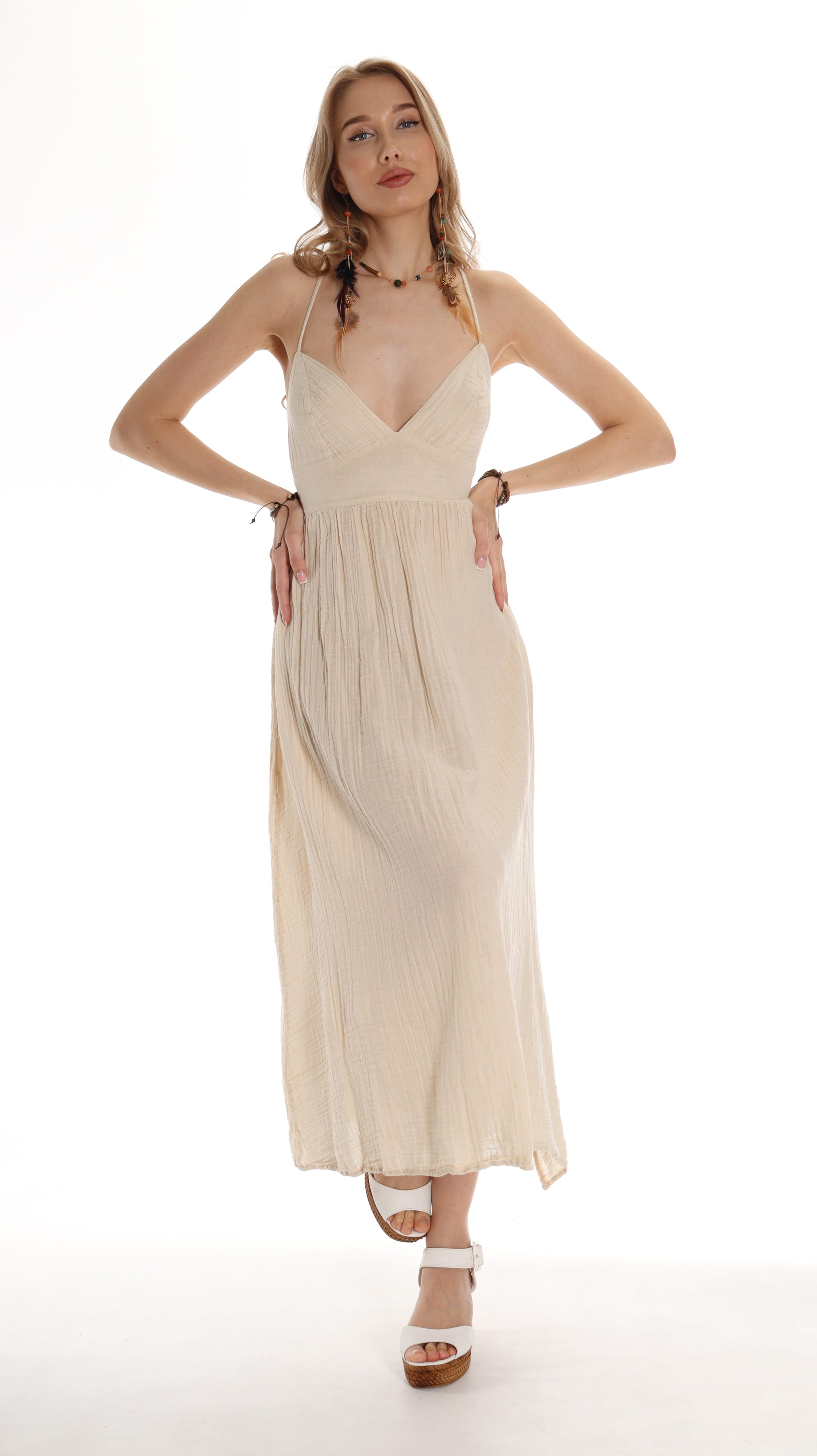 Model wearing a beige boho maxi dress with open back