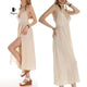 Woman in beige boho cotton maxi dress with open back
