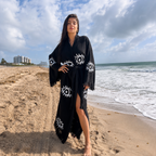 Handcrafted black women's 100% cotton kimono robe with white Evil Eye motifs worn as a lightweight beach cover-up and resort robe by MIYAW Fashion.