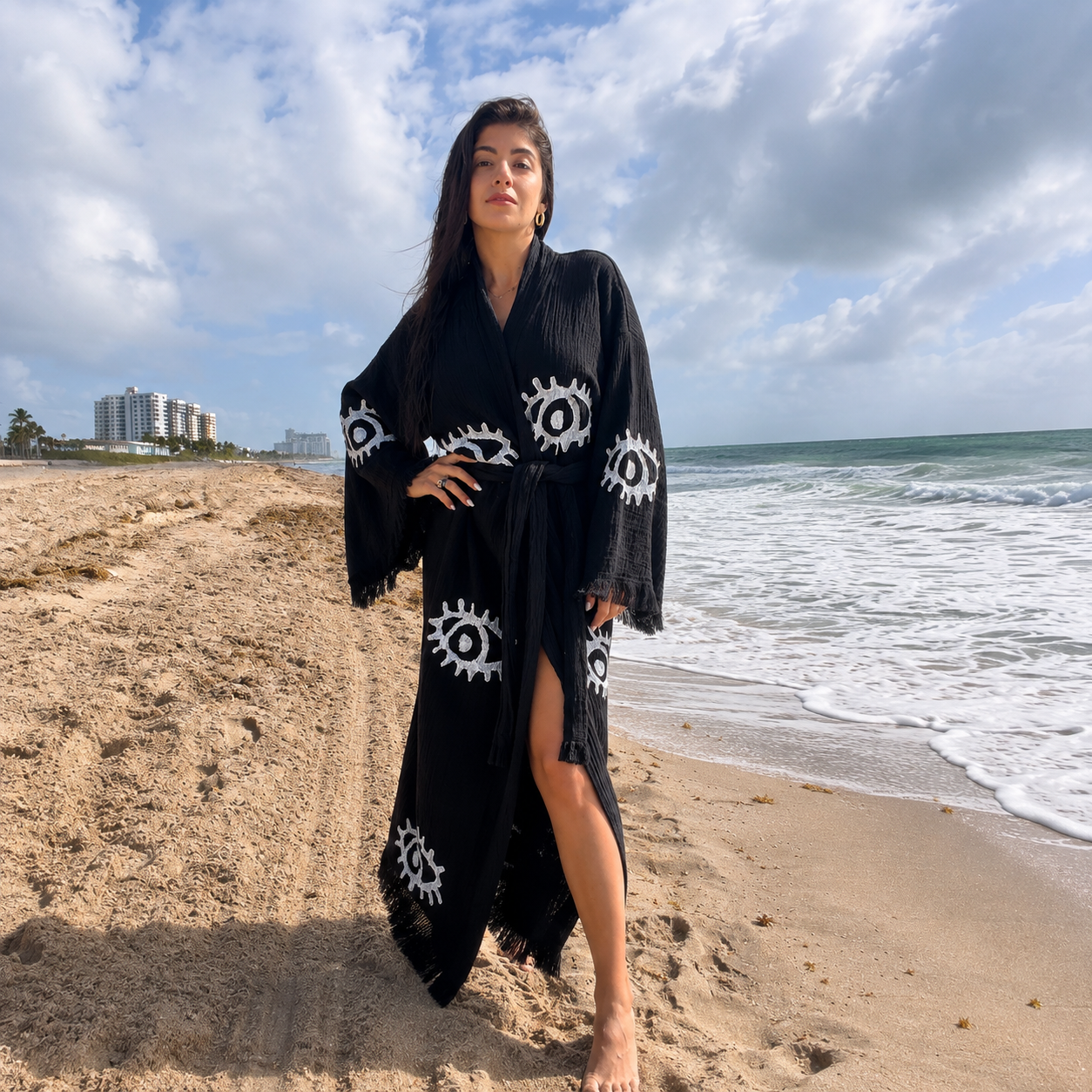 Handcrafted black women's 100% cotton kimono robe with white Evil Eye motifs worn as a lightweight beach cover-up and resort robe by MIYAW Fashion.