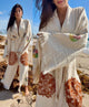 Woman wearing a handmade organic cotton covered up swimwear robe on the beach, styled as an elegant lightweight resort cover up.