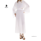 Woman wearing a handcrafted white organic cotton maxi skirt with double front slits styled for boho beach and resort wear by MIYAW Fashion.